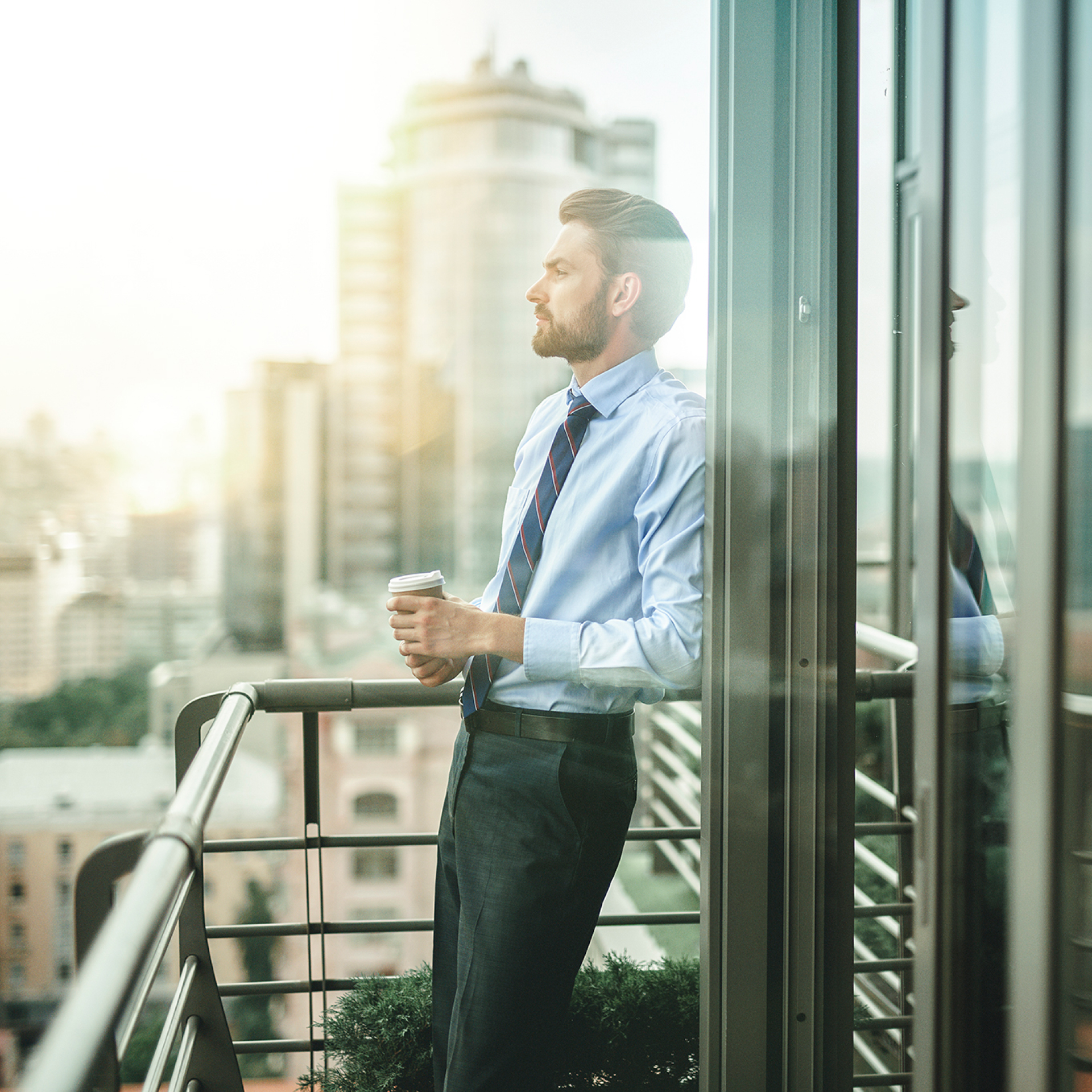 Lexus Corporate programme man drinking coffee on office balcony