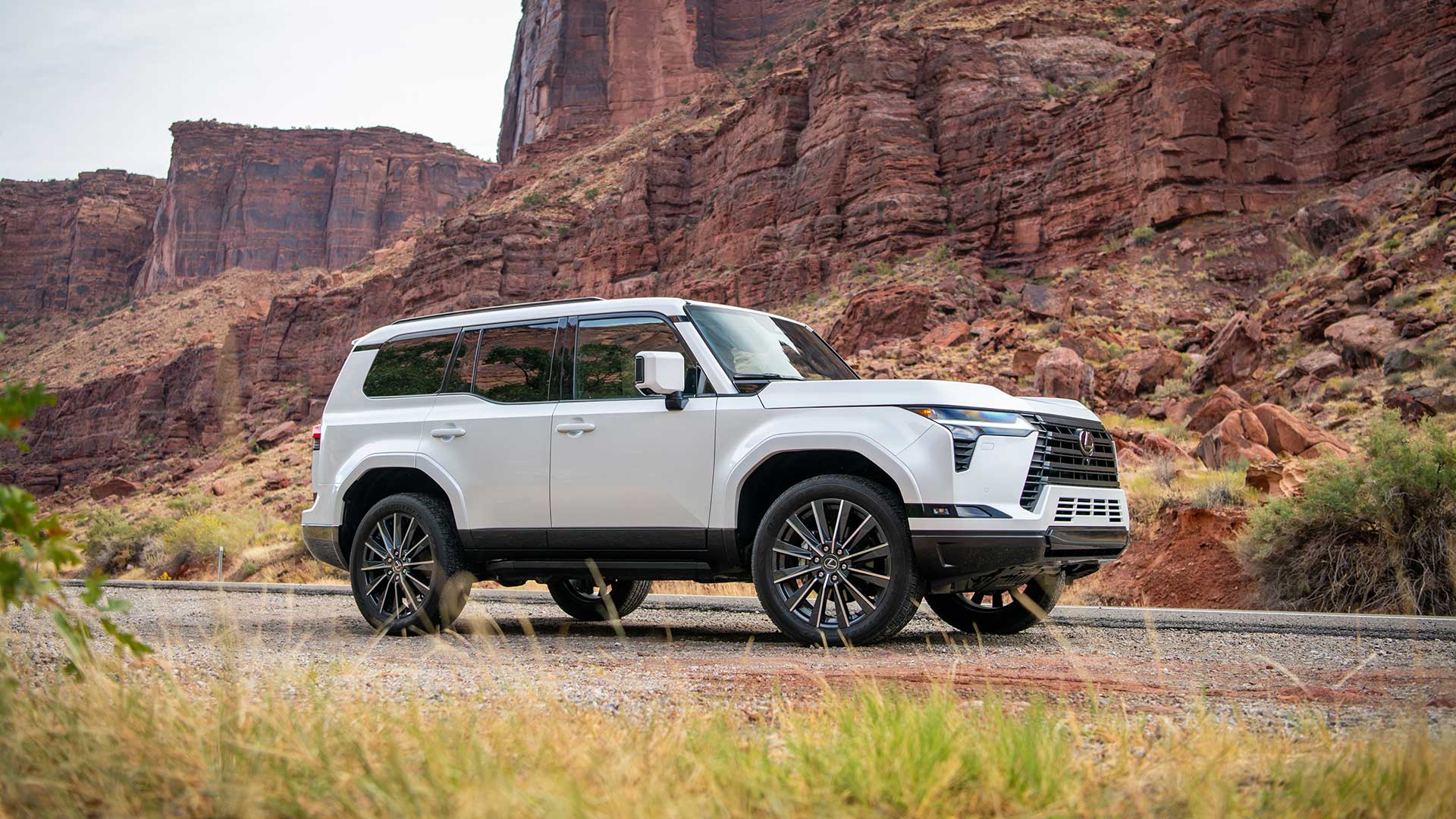 A white Lexus GX 550 parked against a mountainous backdrop